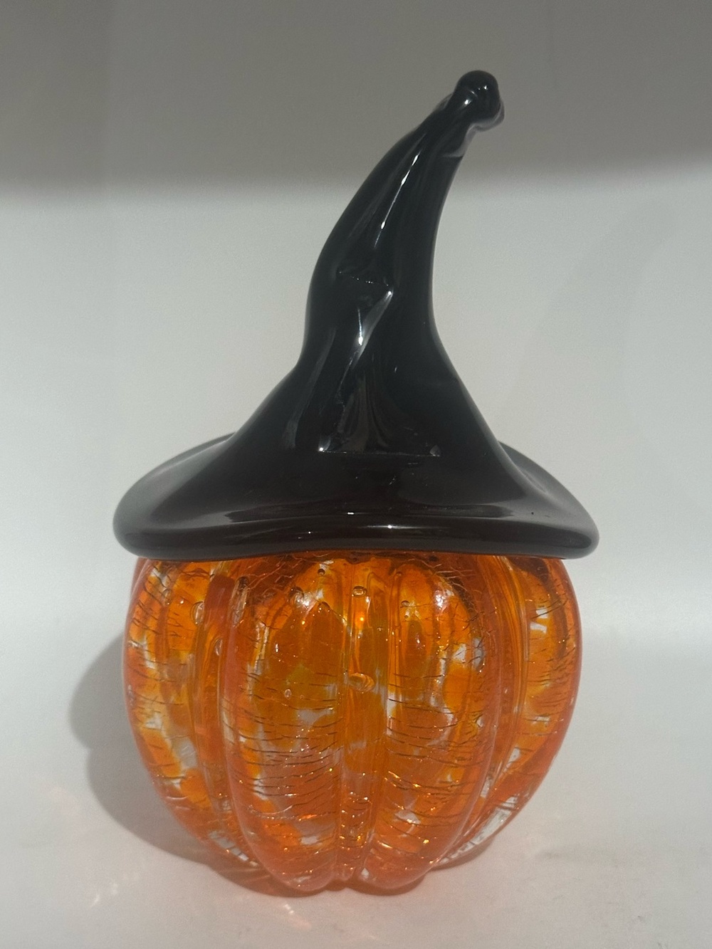 Hand blown pumpkin with which black har.